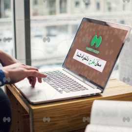 دانلود موکاپ لپ تاپ روی میز چوبی در حال کار کردن